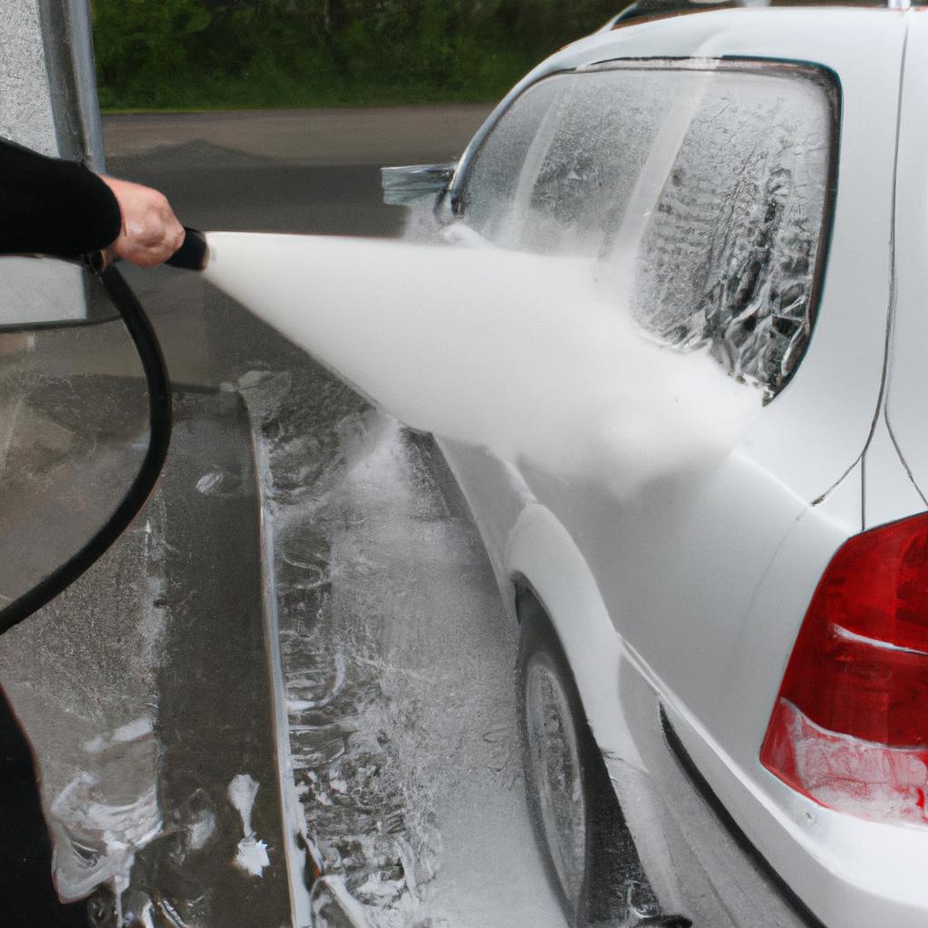 Person using foam cannon for car wash