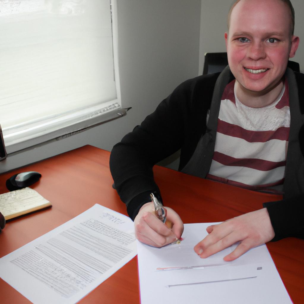Person signing loan paperwork, smiling