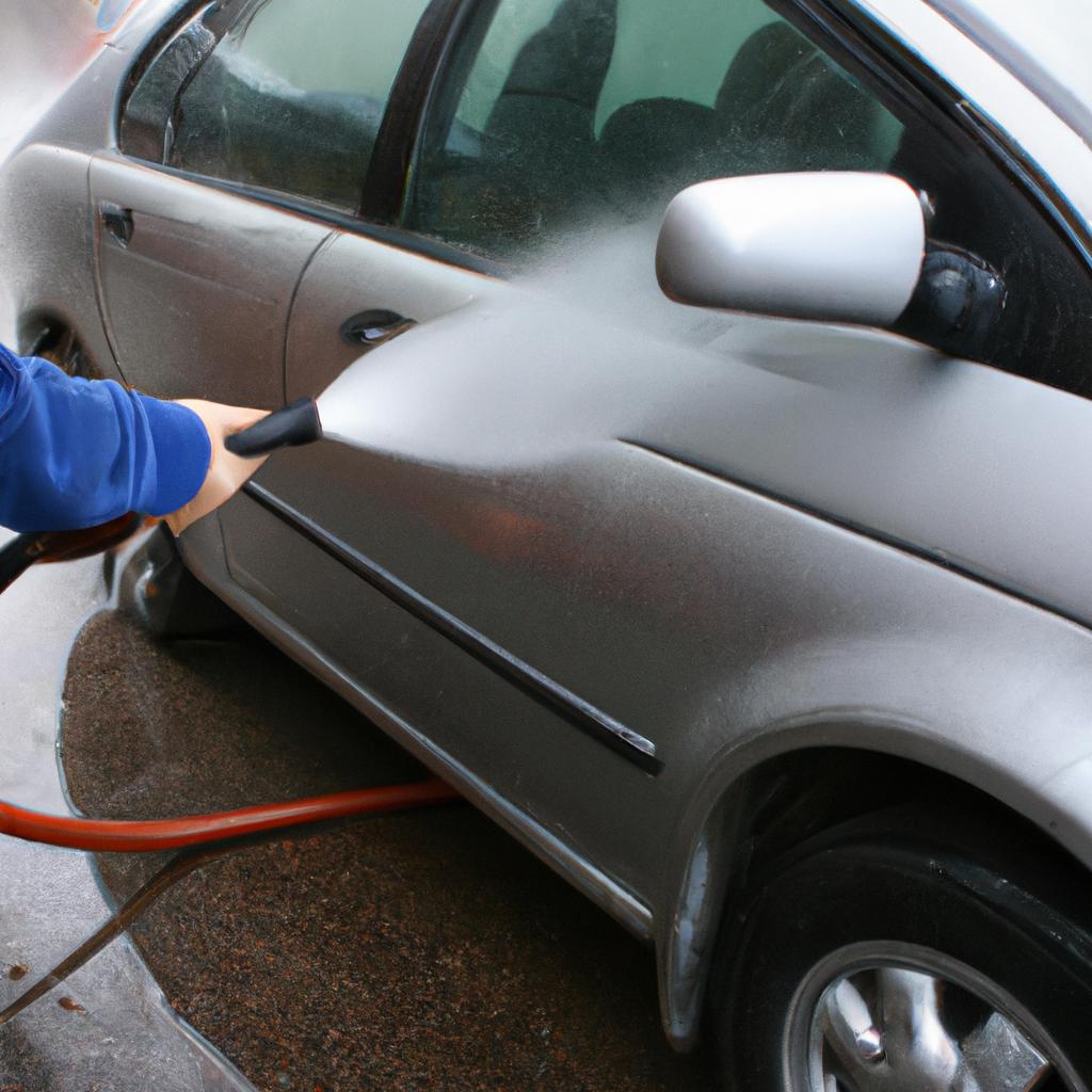 Person using high-pressure car wash
