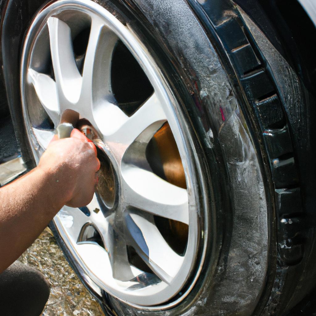 Person cleaning car wheels